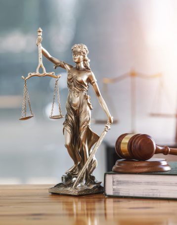 Legal and law concept. Statue of Lady Justice with scales of justice and wooden judge gavel on wooden table. Panoramic image statue of lady justice.
