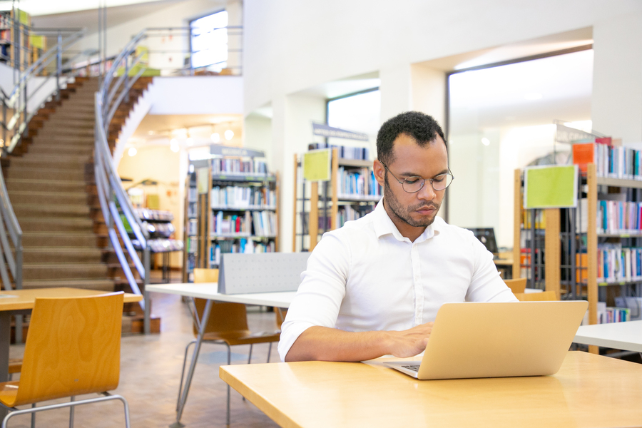 Serious adult student doing research in library